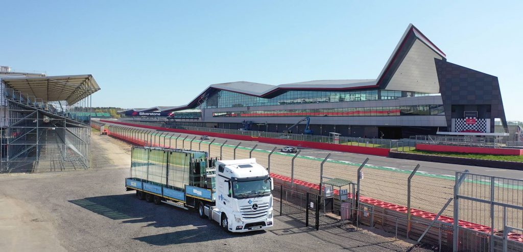 Aerial Image of Carey Glass delivery truck trackside at Silverstone Circuit. Photography by James Thompson uk construction photography. 