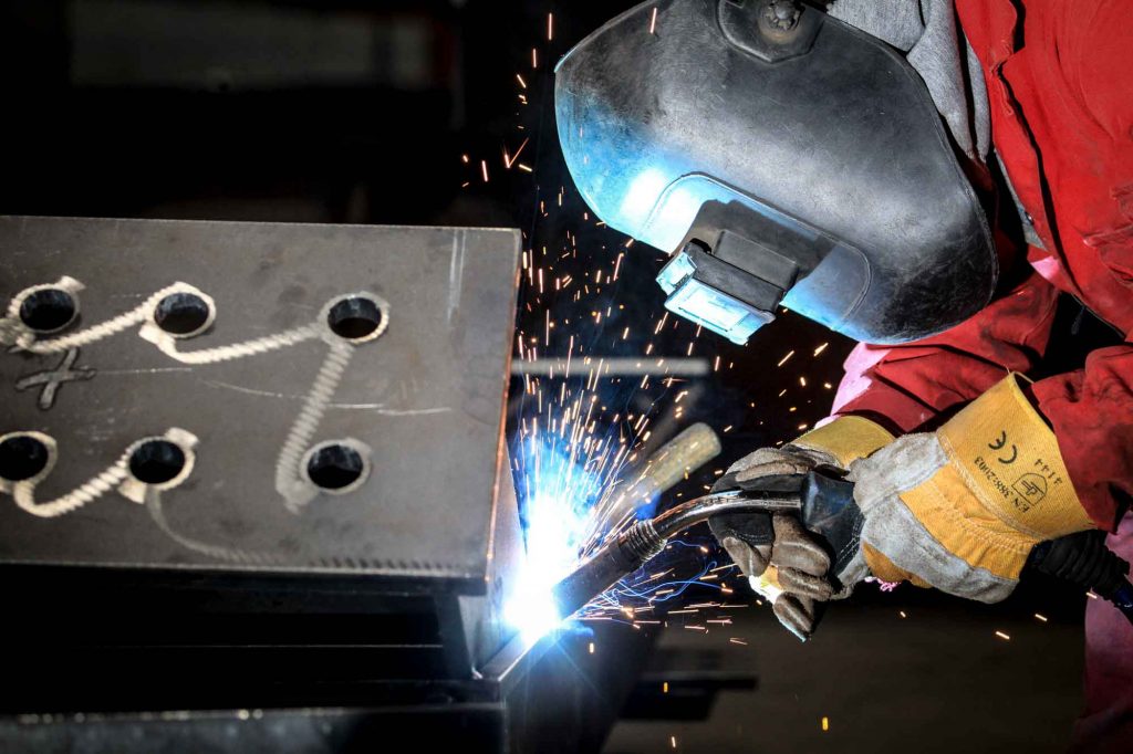 Steel Fabrication Photography close up of steel fabricator welding steel plate. 