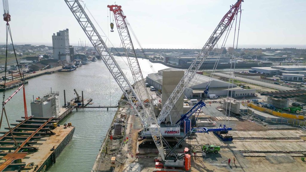 Gull Wing Bridge Lowestoft construction showing multiple massive cranes coordinating marine lifting operations for world's largest rolling bascule bridge installation

