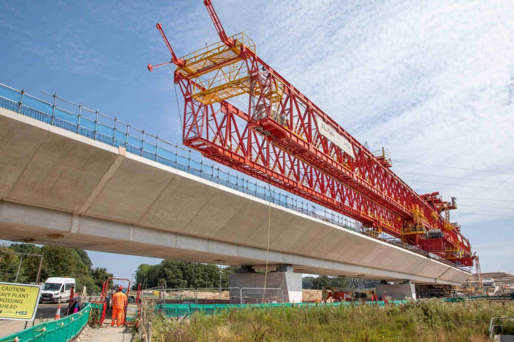 HS2 Colne Valley Viaduct construction showing massive red steel launching gantry installing pre-cast concrete segments for Britain's longest rail bridge