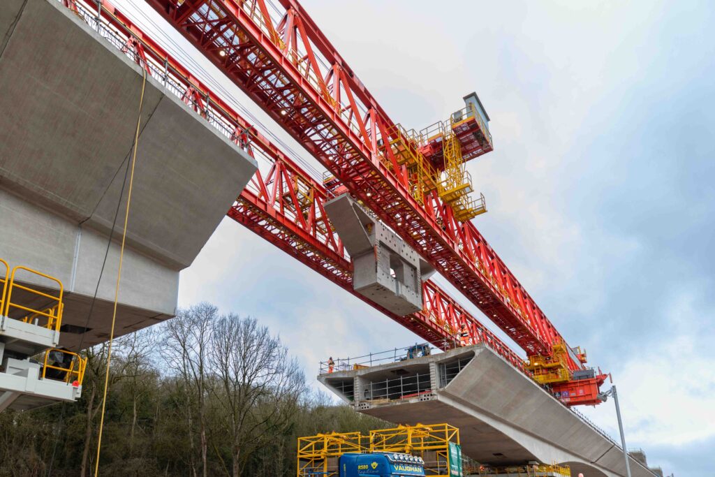 Launching girder lifting a precast concrete segment into place on the HS2 Colne Valley Viaduct